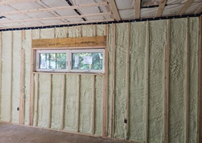 spray foam insulation surrounding two small windows